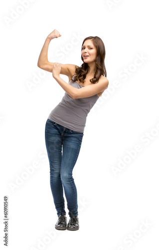 Full-length portrait of woman showing bicep, isolated