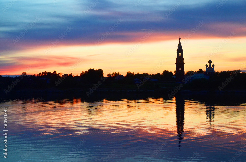Beautiful sunrise on river Volga with church