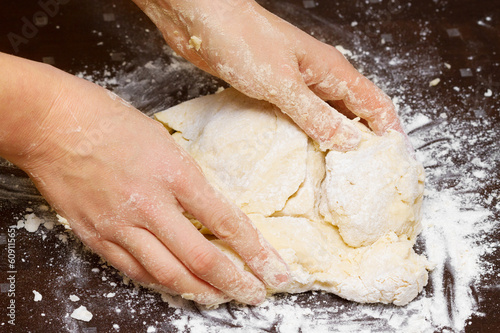 female hands kneading dough