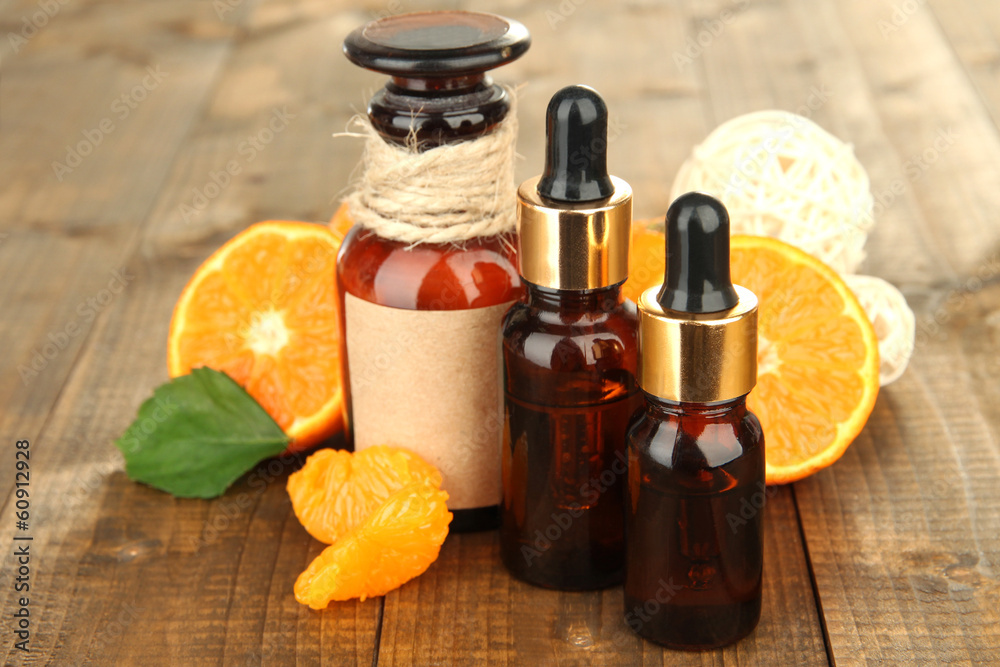 Tangerine essential oil and tangerines on wooden table