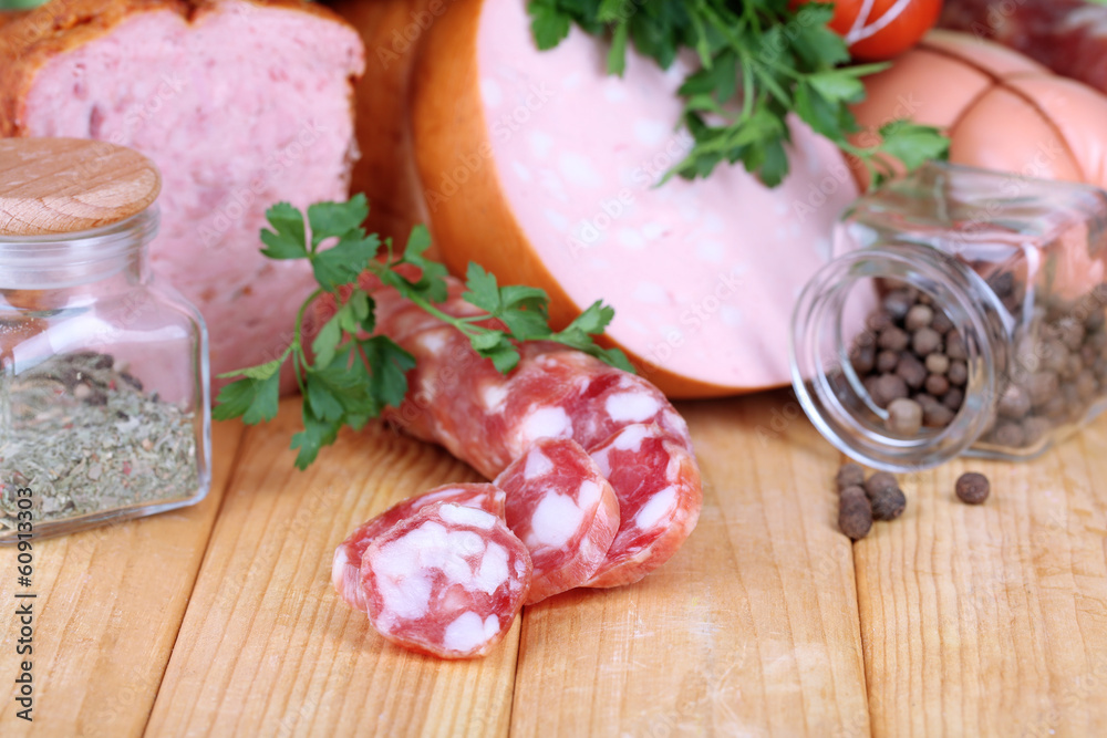 Lot of different sausages on wooden table on natural background Lot of different sausages on wooden table on natural background