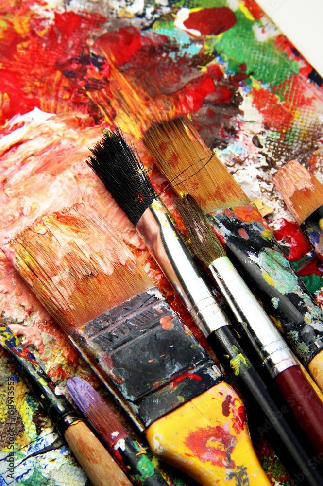 Beautiful vivid art palette and mix of paintbrushes