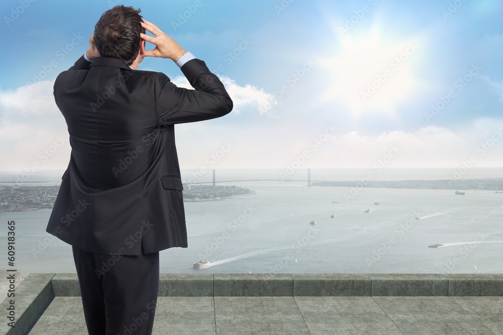 Composite image of stressed businessman with hands on head Composite image of stressed businessman with hands on head