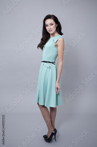Beautiful young woman in a turquoise dress