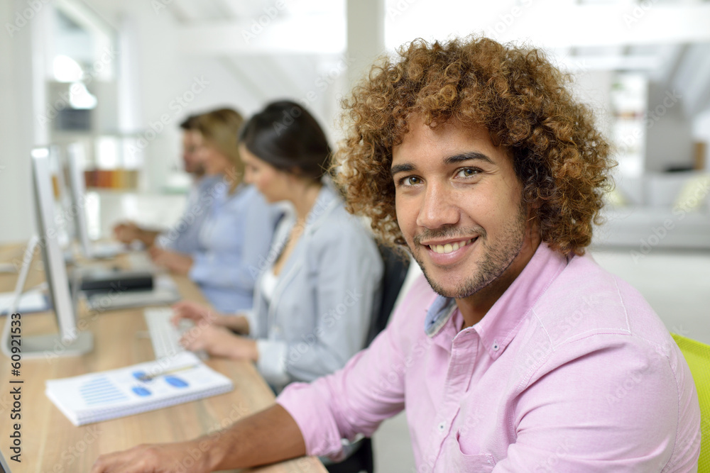 Young businessman in office working on laptop