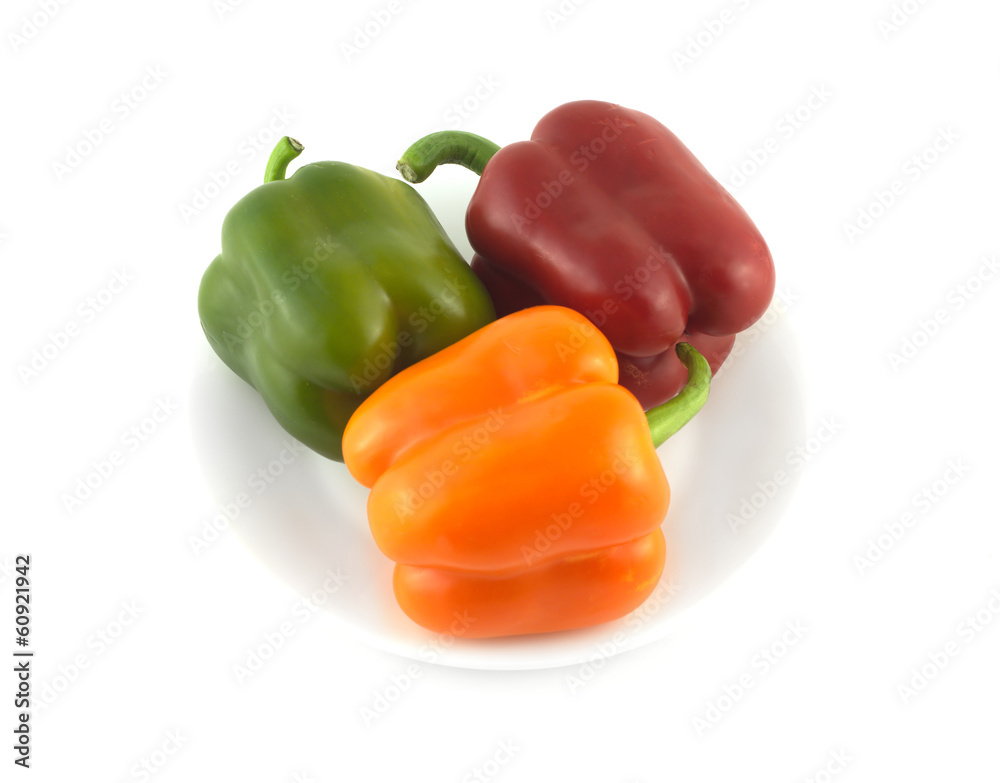 Color beel peppers on plate isolated close up Color beel peppers on plate isolated close up