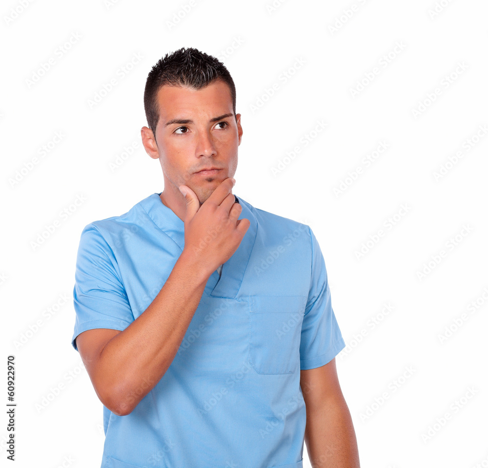 Pensive male nurse on blue uniform standing Pensive male nurse on blue uniform standing