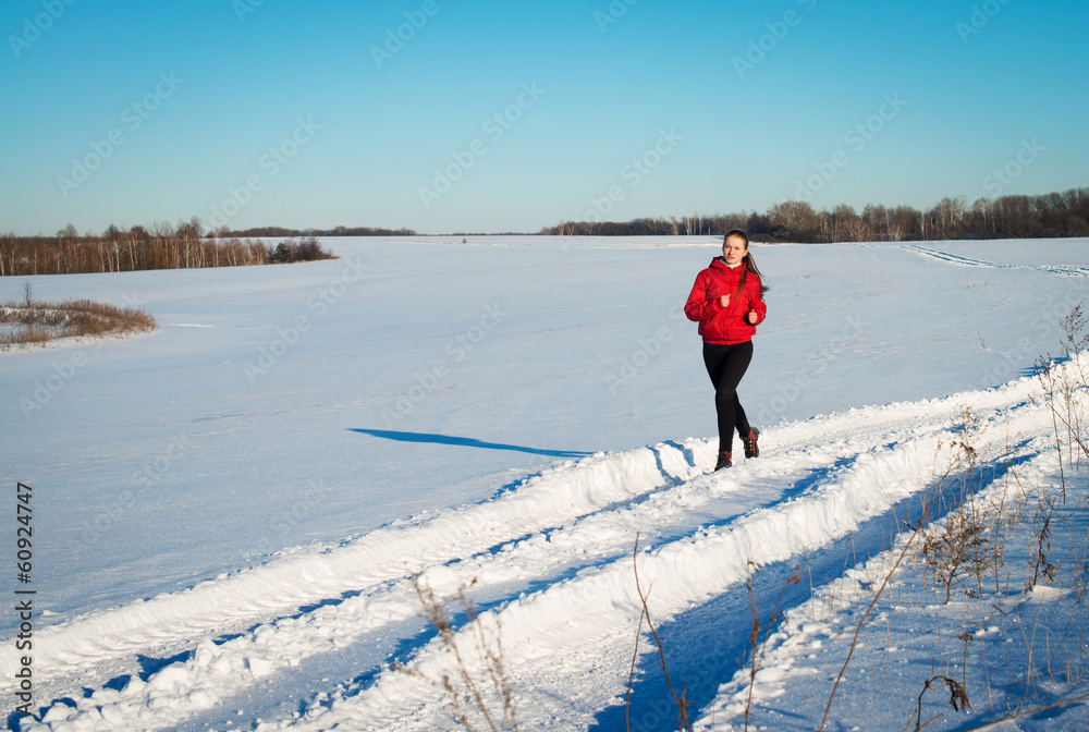 Young girl runner. Winter nature.