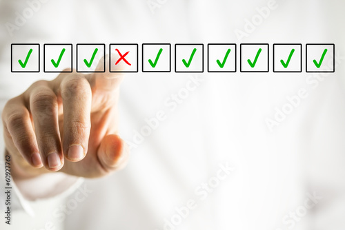 Fotografie Man selecting a cross from a line of check marks