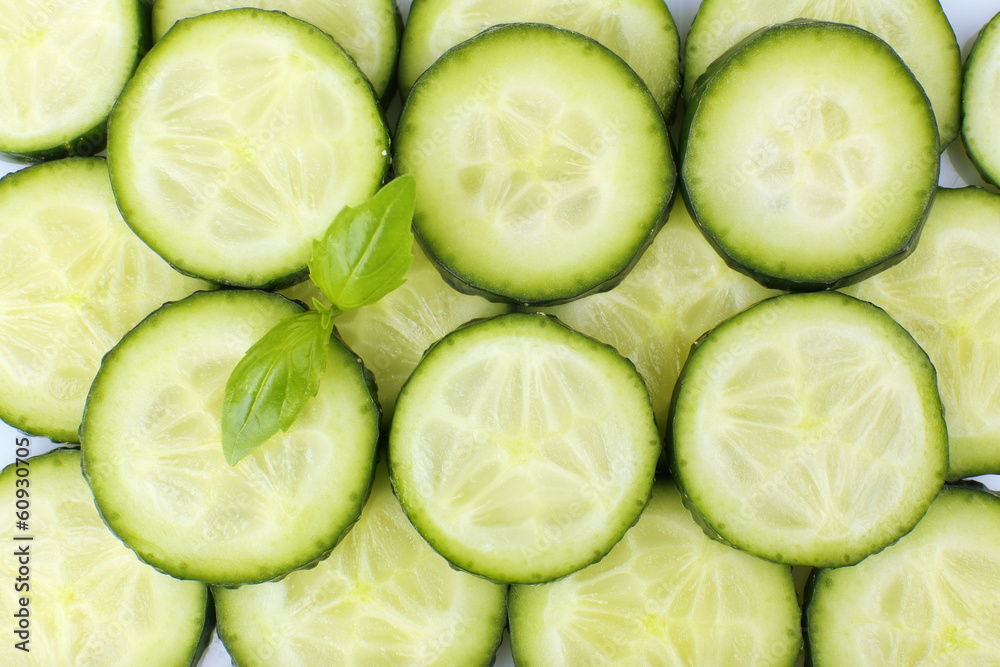 Slices of fresh cucumber with basil, close up Slices of fresh cucumber with basil, close up