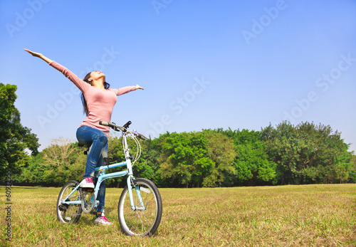young woman relaxing pose and sitting on bike