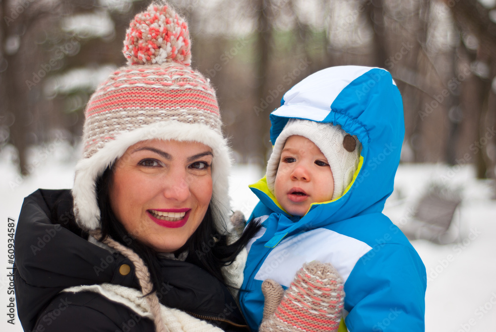 Happy mother and baby boy in winter
