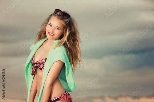 Blonde in tropical bikini on the beach