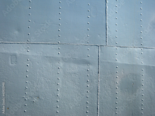 Detailed gray metal historic ship wall with seams and rivets