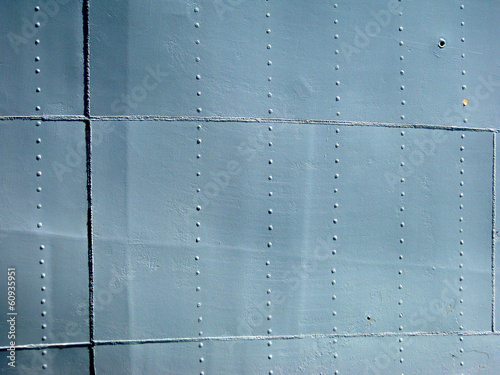 Detailed gray metal historic ship wall with seams and rivets. wi