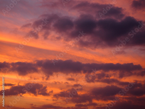 Sunset casts red light into the clouds stretching into the dista © Eric BVD