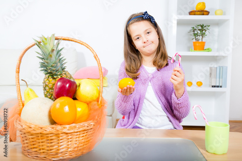 little girl with a lollipop and fruit