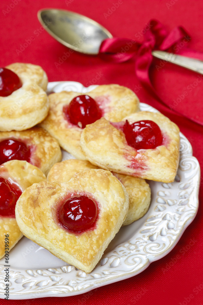 Puff pastry cookies in heart shape filled with cherries Puff pastry cookies in heart shape filled with cherries