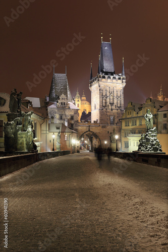 Night snowy Prague Charles Bridge and St. Nicholas' Cathedral