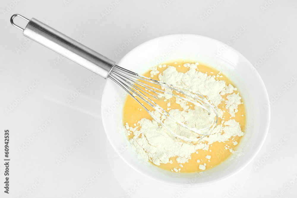 Corolla and broken eggs with flour isolated on white Corolla and broken eggs with flour isolated on white