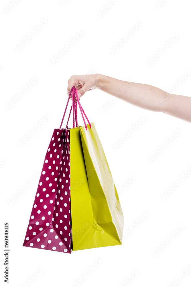 Hand holding colorful shopping bags, isolated on white backgroun
