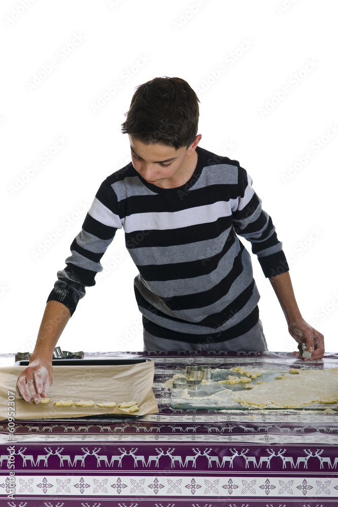 Junge rollt Teig aus und sticht Plätzchen aus. Junge rollt Teig aus und sticht Plätzchen aus.