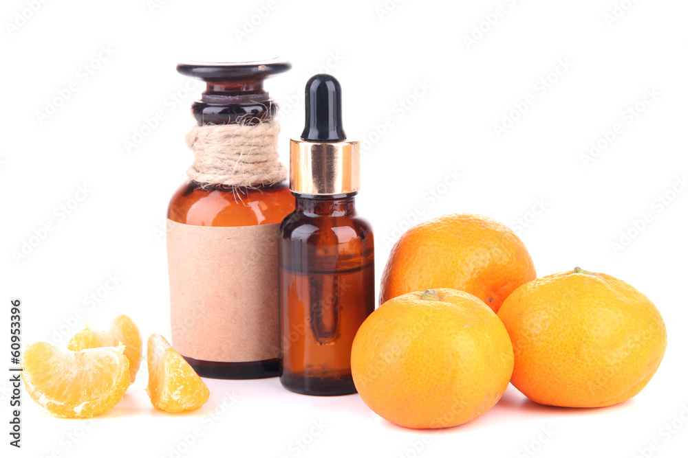 Tangerine essential oil and tangerines, isolated on white Tangerine essential oil and tangerines, isolated on white