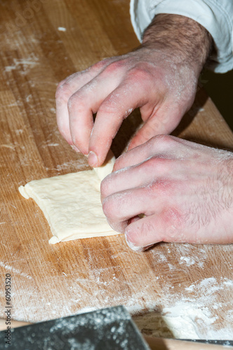 Baker preparing chocolate croissant