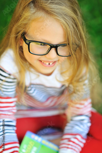 Closeup of cute little girl in glasses - outdoor