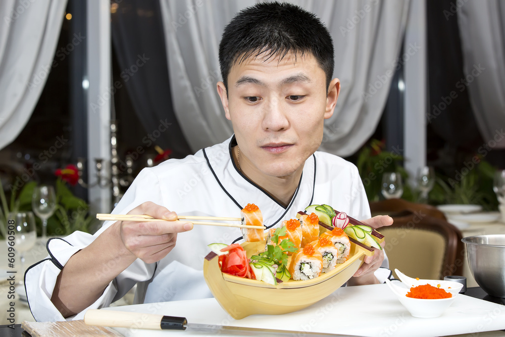Japanese chef preparing a meal in a restaurant Japanese chef preparing a meal in a restaurant