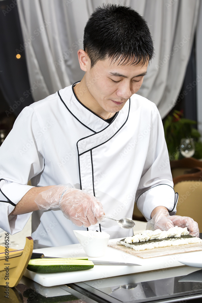Japanese chef preparing a meal in a restaurant Japanese chef preparing a meal in a restaurant