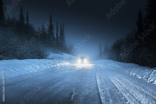 Car lights in winter Russian forest © Iakov Kalinin