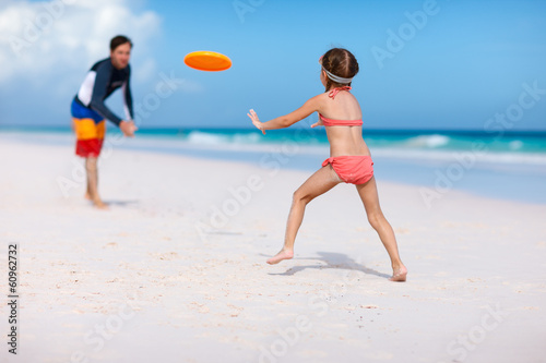 Father and daughter playing frisbee