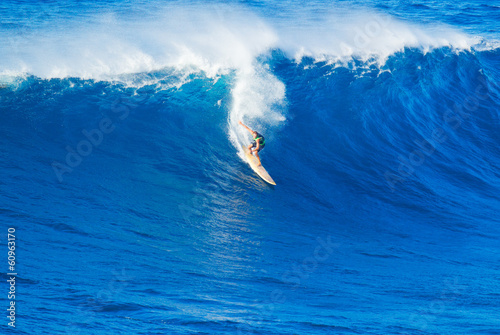 Surfer riding giant wave