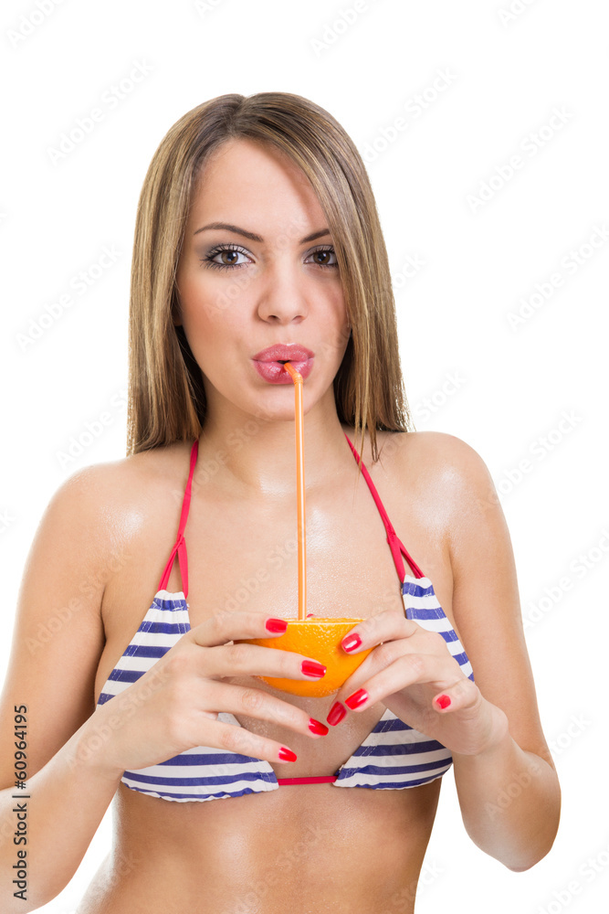 Cute young woman in bikini drinking orange juice Cute young woman in bikini drinking orange juice