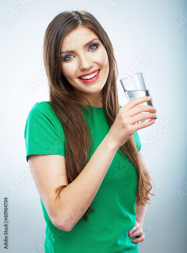 Young woman posing on isolated studio background, hold water gl