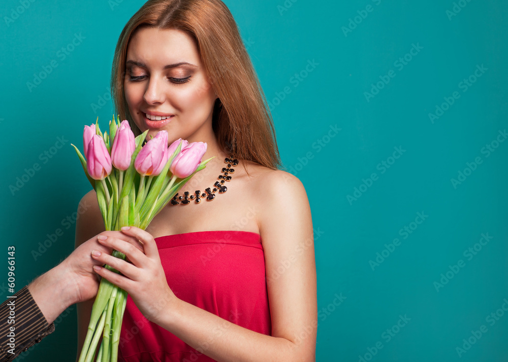 Young beautiful girl gives a bouquet of tulips man Young beautiful girl gives a bouquet of tulips man