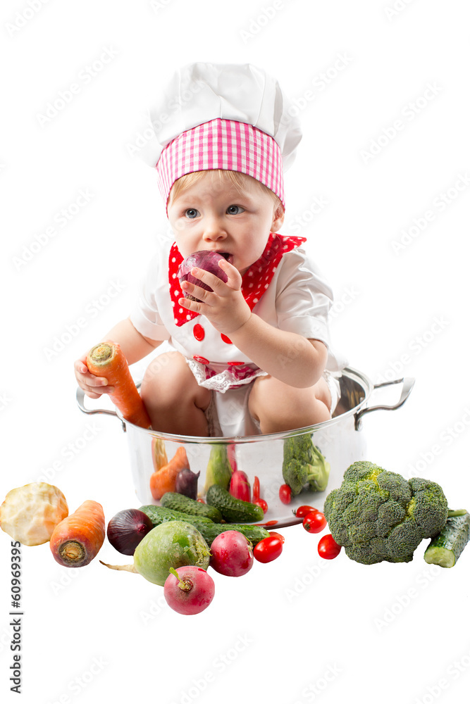 Baby cook girl wearing chef hat with fresh vegetables Baby cook girl wearing chef hat with fresh vegetables