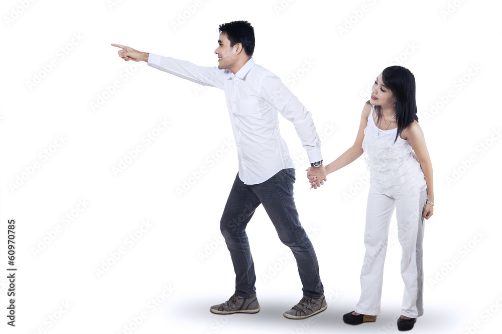 Romantic couple pointing at copy space Romantic couple pointing at copy space