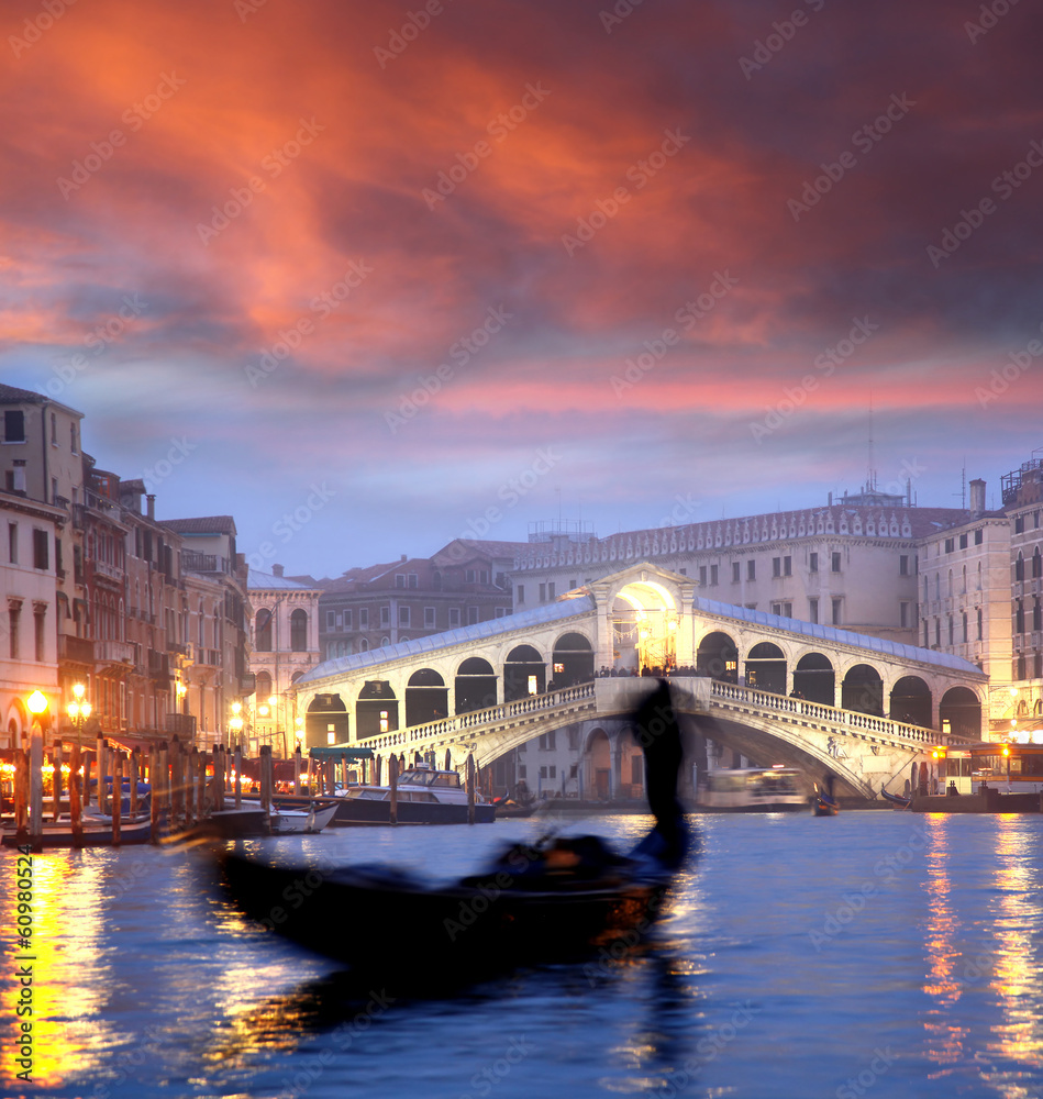 Venice with gondola against Rialto bridge in Italy