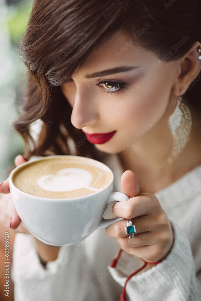 Young girl drinking coffee in a trendy cafe Young girl drinking coffee in a trendy cafe