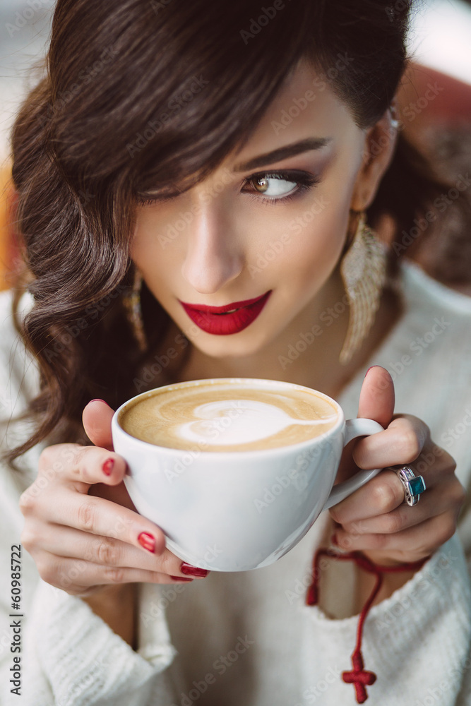 Young girl drinking coffee in a trendy cafe Young girl drinking coffee in a trendy cafe