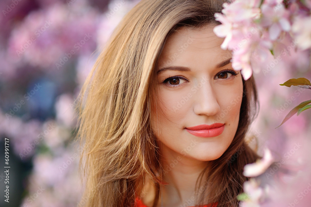 Beautiful woman among spring blossom Beautiful woman among spring blossom