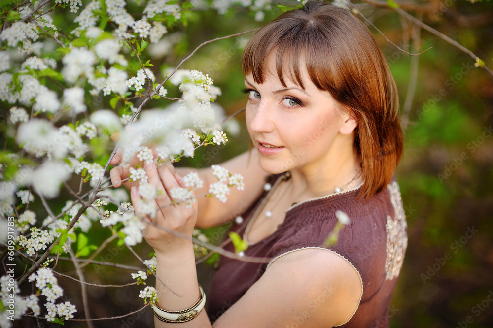 Beautiful young girl in a park on a spring day Beautiful young girl in a park on a spring day