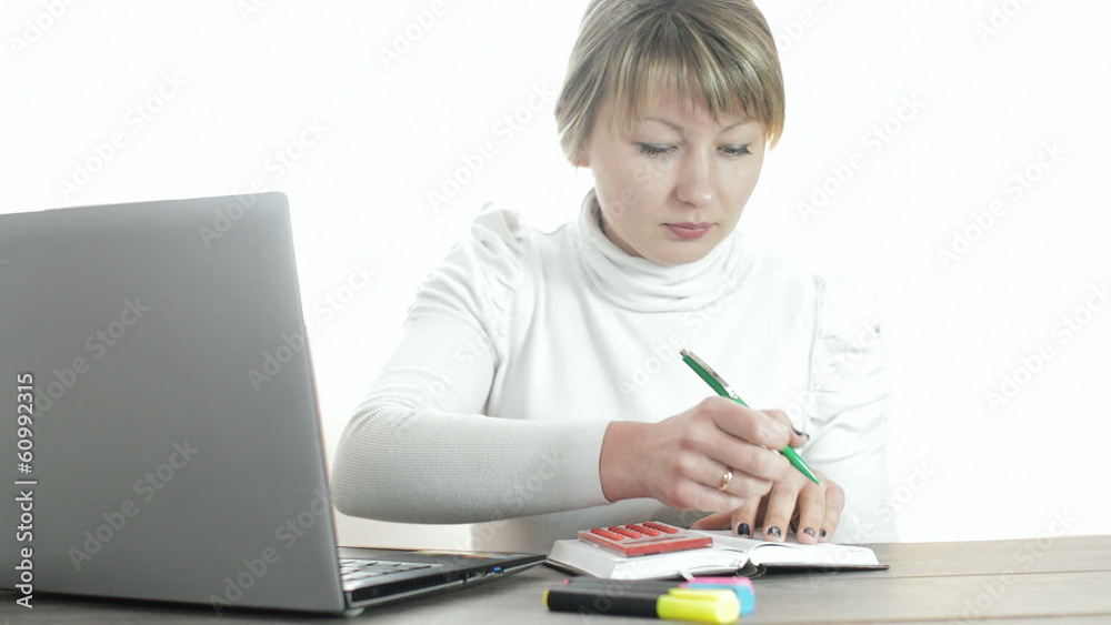 young woman considers on the calculator young woman considers on the calculator