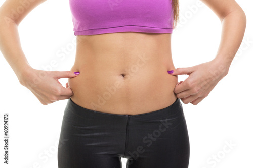 Fit woman pinching fat on her waist