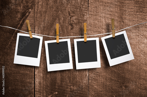 photo paper attach to rope on wooden background