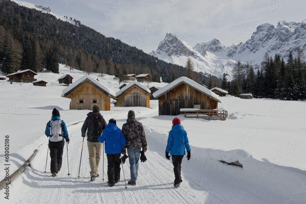 Group Hiking on a snowy Trail to mountain Huts