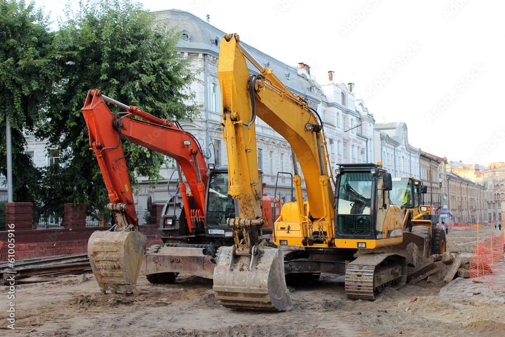 two modern excavators working on the Lvov's street