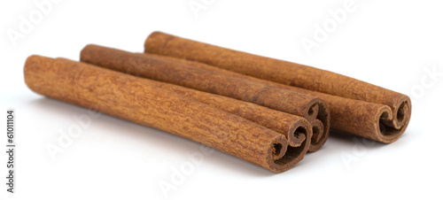 cinnamon sticks stacked on white background